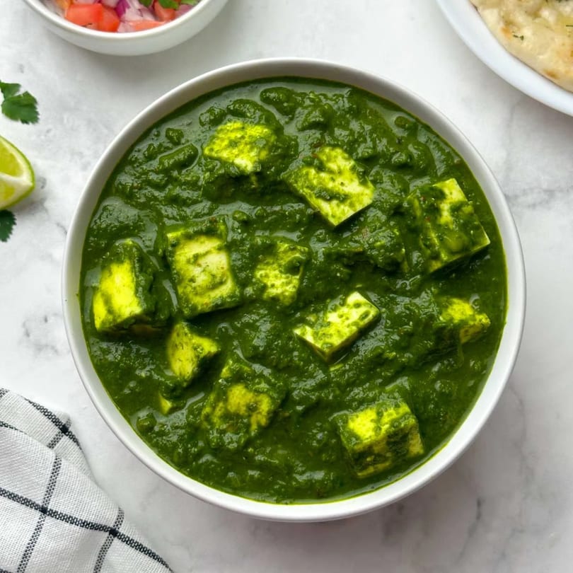 Bawarchi Biryanis' Palak Paneer, a vibrant green Indian dish with paneer cubes in spinach gravy.